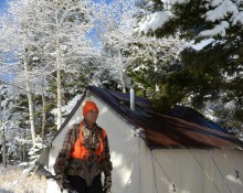 Hunter leaving wall tent